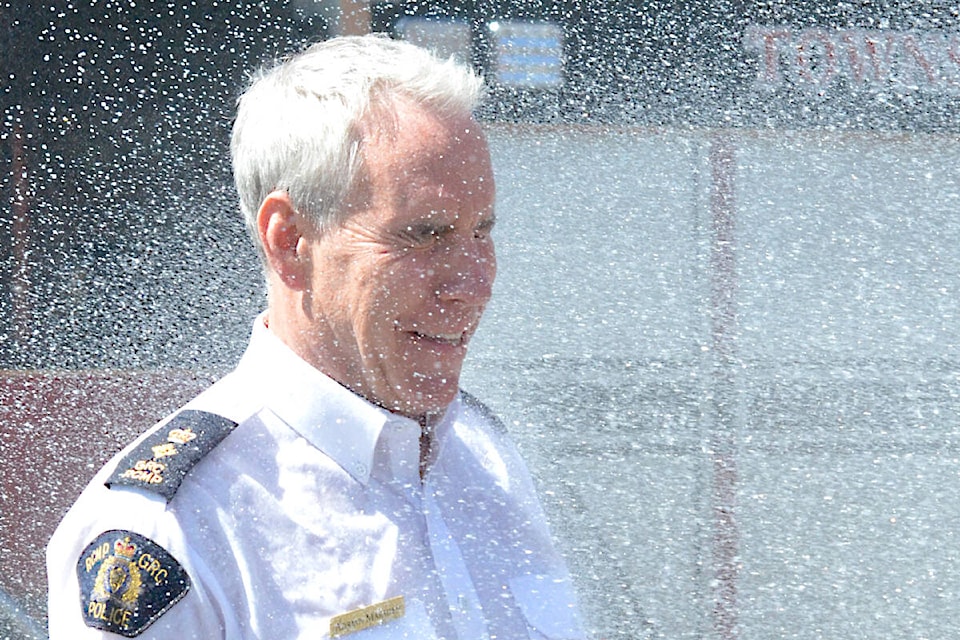 This is what happens when you lose a contest with the fire department. 91ԭ RCMP Supt. Adrian Marsden was hosed down Monday morning, June 5, after the detachment came second in a blood donation challenge. (Dan Ferguson/91ԭ Advance Times)