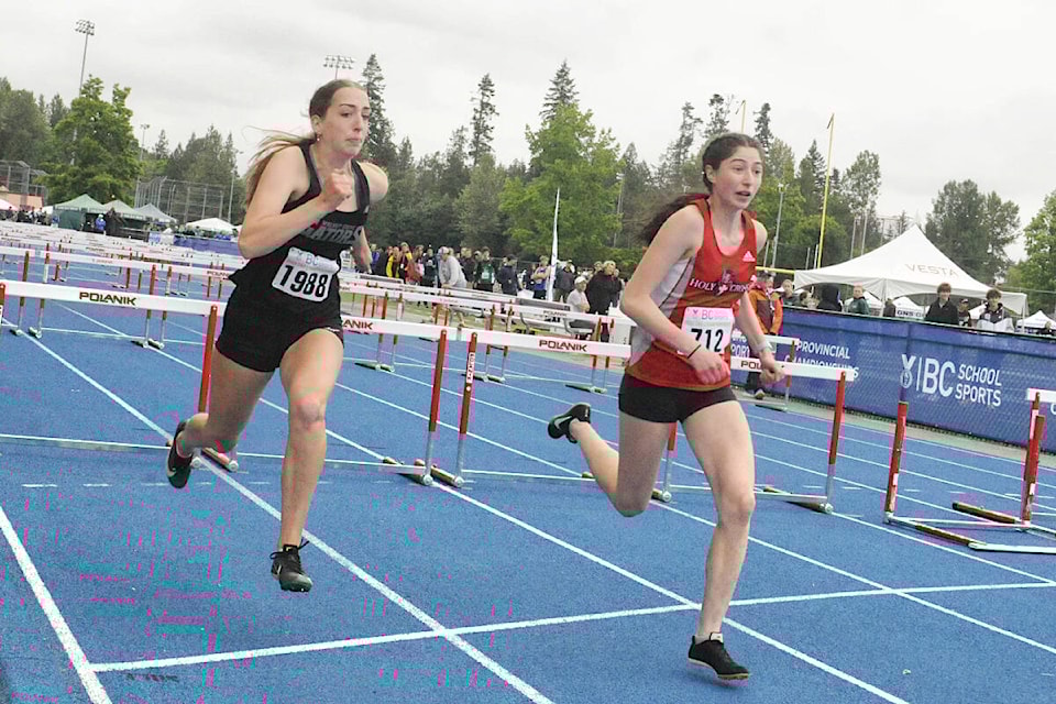 Walnut Grove Secondary’s Kaitlin Gelowitz (L) battled with Holy Cross Regional High School rival Claire Nichol (R) in the hurdles at the B.C. School Sports Track and Field Provincial Championships held at 91ԭ McLeod Athletic Park June 8-10. (Heather Colpitts/91ԭ Advance Times)