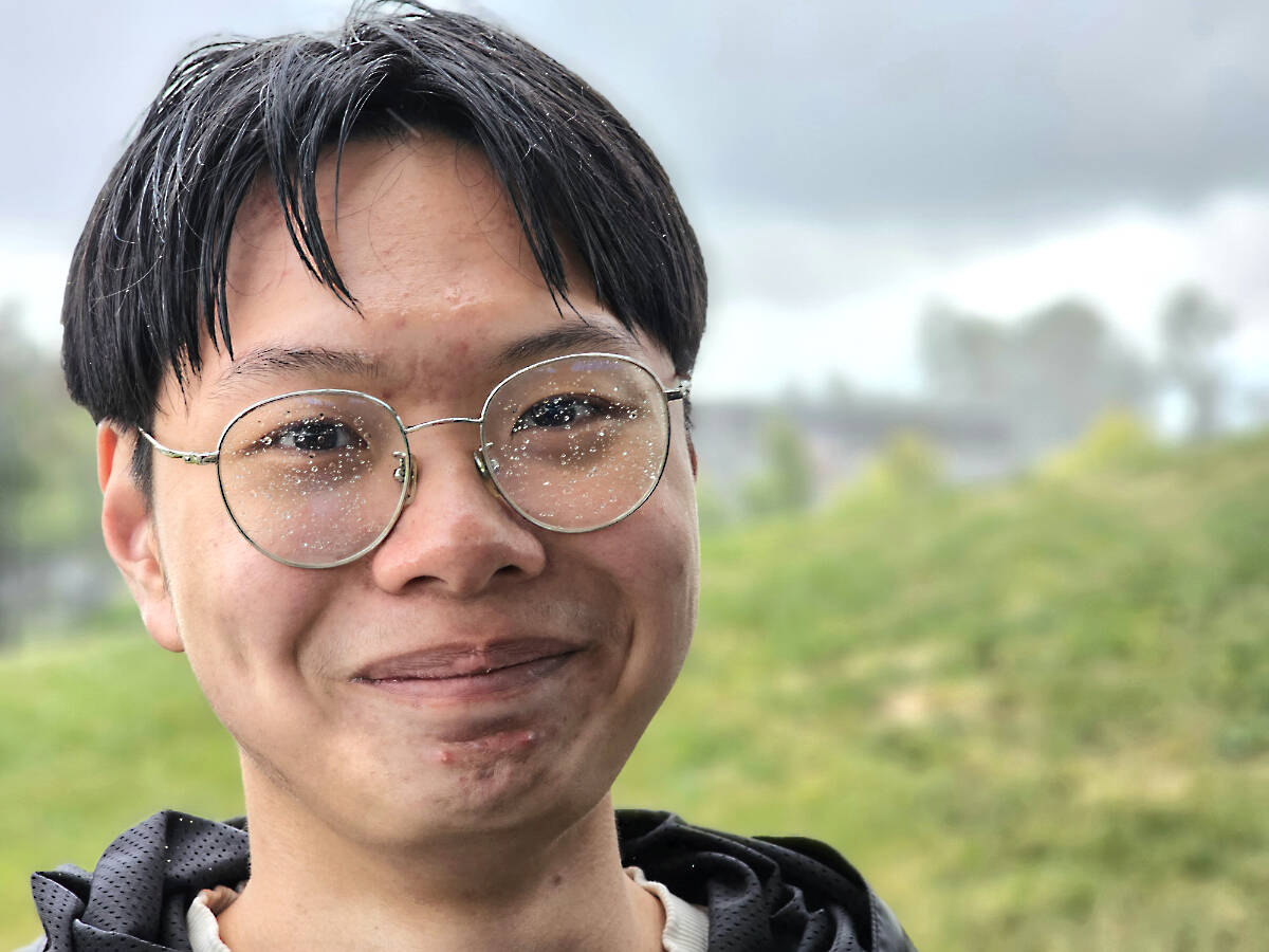 Student Guongdao Yang was part of a rain- and hail-drenched cleanup effort that saw more than 20 international students pick up litter in 91原创聮s Willoughby Park near R.E. Mountain School. (Dan Ferguson/91原创 Advance Times)