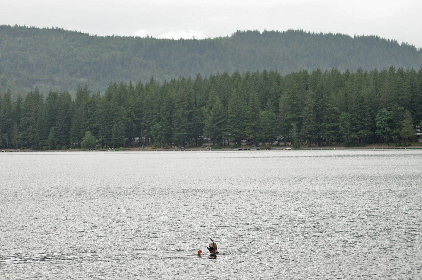 Steve Clegg collects trash at Cultus Lake on Friday, June 16, 2023. (Jenna Hauck/ Chilliwack Progress)