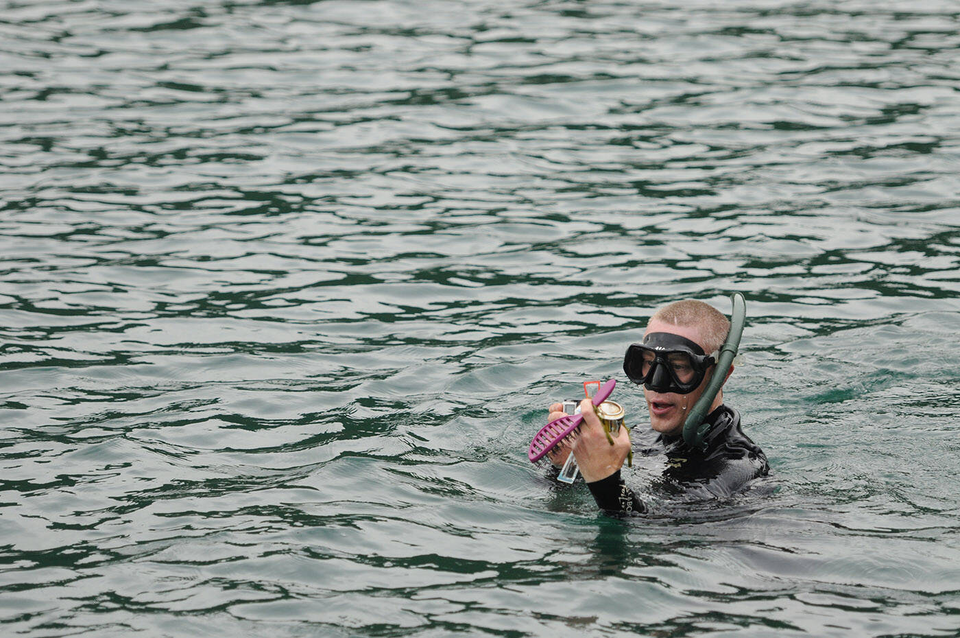 Steve Clegg collects trash at Cultus Lake on Friday, June 16, 2023. (Jenna Hauck/ Chilliwack Progress)