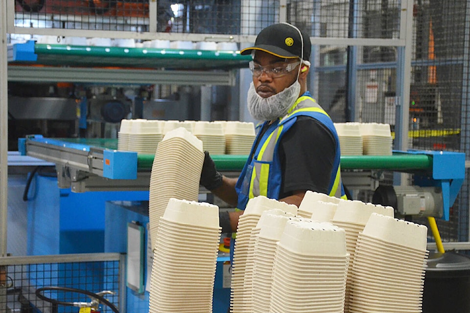 Kashwyane Miller, a CKF employee, stacked Earthcycle containers at the end of the production line. (Matthew Claxton/)