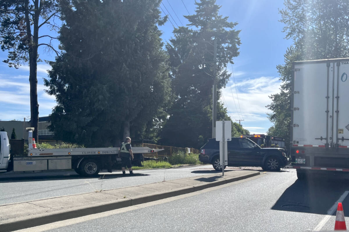 A crash involving a Land Rover and semi truck had a section of 62 Avenue and 201A Street blocked Thursday morning. (Tammy Berry/91原创 Advance Times)