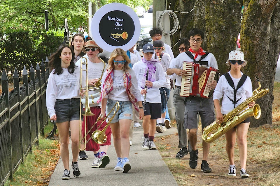 Noxious Obs at the New Orleans-style Mardi Gras strolling parade that opened the Fort 91ԭ Jazz & Arts Festival opening Saturday morning, July 22. (Dan Ferguson/91ԭ Advance Times)