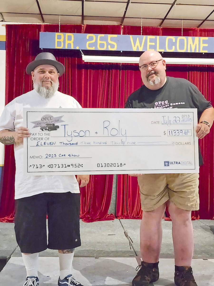 This year聮s Old Farts Car Club show raised a record $11,339 to help two families battling cancer. Dad Tyson(left) and granddad Roly attended the cheque presentation on July 22 at the Royal Canadian Legion Aldergrove branch, where the latest edition of the fundraiser was held. (Special to 91原创 Advance Times)