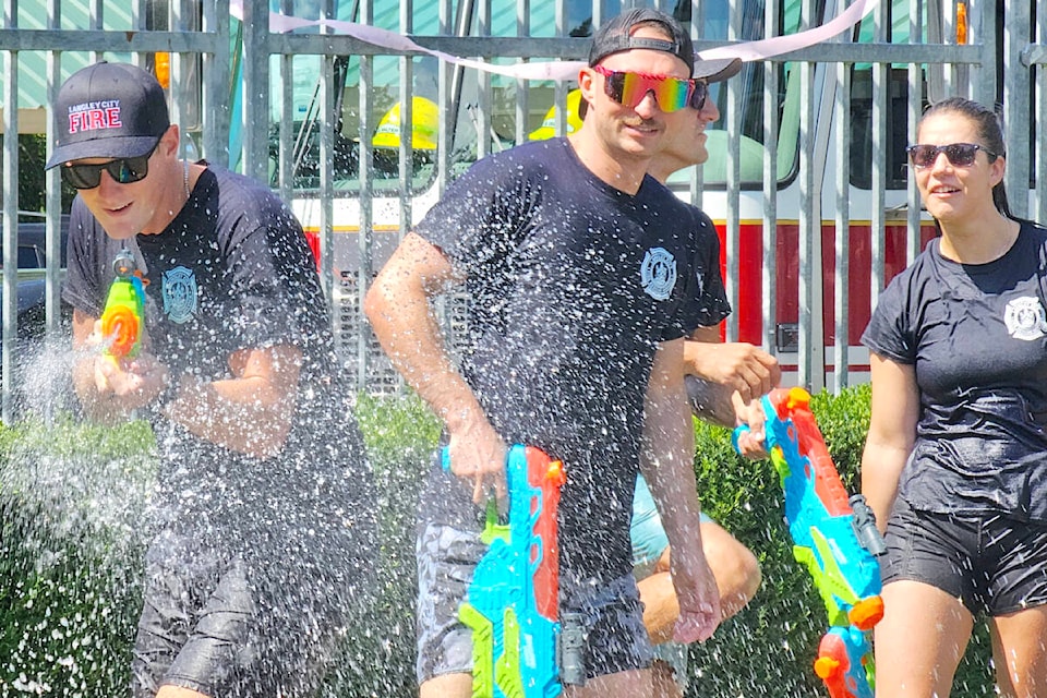 Instead of fire hoses, fire fighters used super soaker water guns at the annual Legendary Water Fight, held at Al Anderson Memorial Pool on Saturday, Aug. 12 under Stage 2 water restrictions. (Dan Ferguson/91ԭ Advance Times)
