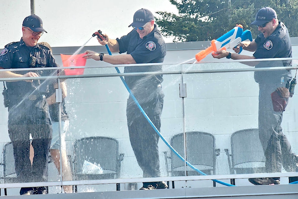 On a scorchingly hot day, some 91ԭ RCMP officers and fire fighters celebrated the 150th anniversary of the Township with a water fight at the Aldergrove Credit Union Community Centre on Saturday, Aug. 26. (Dan Ferguson/91ԭ Advance Times)