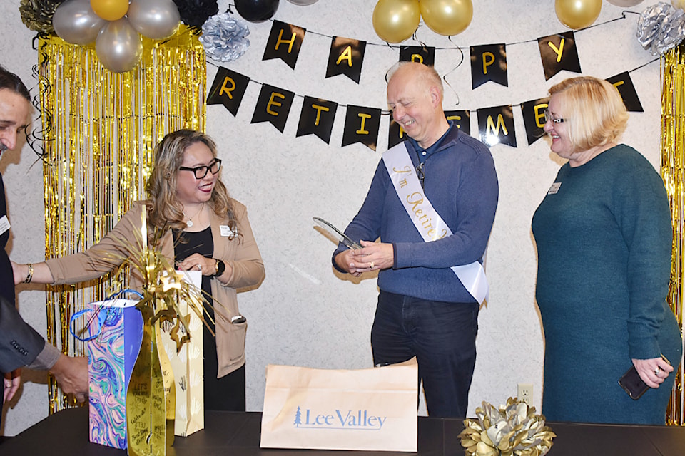 Dr. Martin Milewski receives a gift from staff at Holyrood Manor marking his retirement after four decades. 