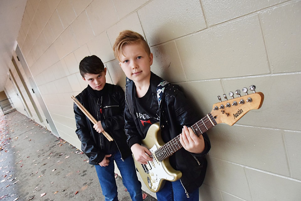 From left, Logan Maltais, 10, Miles Van Sickle, 9, have formed a heavy metal band and are looking for new members.  