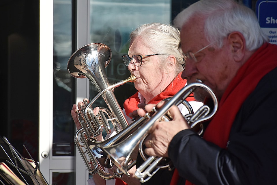 Major Lisa MacPherson, left, plays the E flat horn with the Salvation Army Ridge Meadows Ministry's brass band outside ValleyFair Mall on Friday for the kickoff of the Christmas kettle campaign.