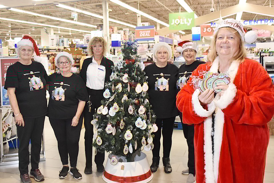 From left: Judy Ballard, Jackie Oxford, London Drugs store manager Elly Kurucz, Lillian Haider, Suzanne Gauthier, and Bev Schmahmann, outreach coordinator with the Ridge Meadows Seniors Society, outside the London Drugs store at ValleyFair Mall where the Stocking Stuffers for Seniors Christmas tree is set up.