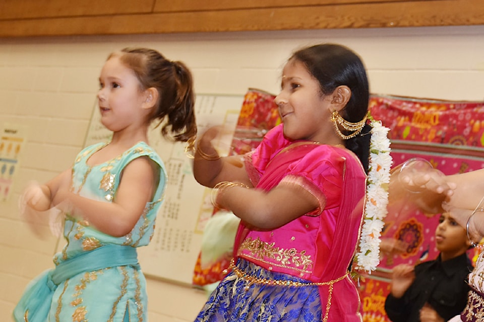 Grade 1 students Julia Jones, left and Veda Gurrapu perform a dance for Diwali at Harry Hooge Elementary. 