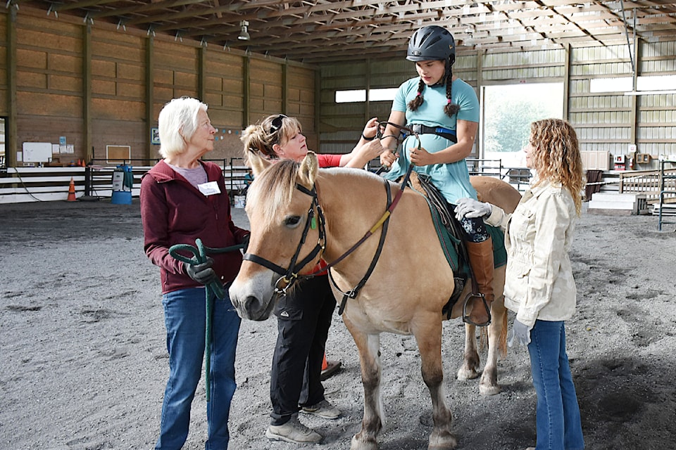 Selina Gonzales, 15, on Inga during her therapy session at the North Fraser Therapeutic Riding Association. 