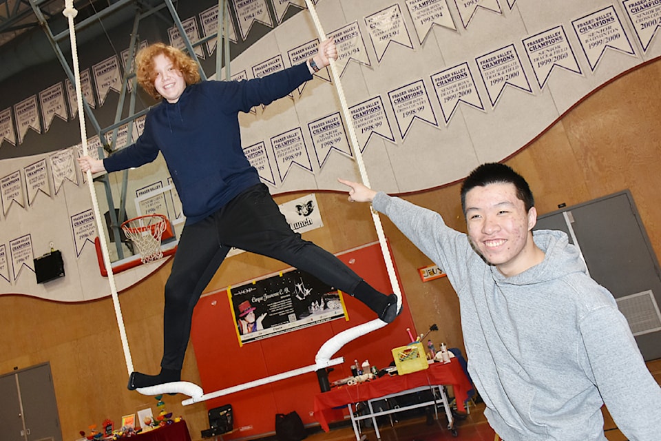 Matteo Lalande, a Grade 10 student at Maple Ridge Secondary, balanced on the trapeze to the delight of his friend. 