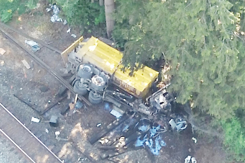 A truck on its side just east of Lougheed Highway and 272 Street, after being hit by a train at an uncontrolled train crossing, on Tuesday, Aug. 26. 