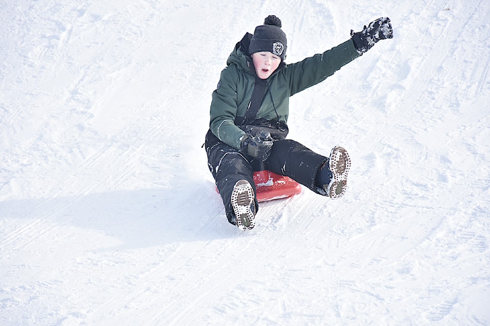 Seven Tyson, 13, flies down the hill at Jim Hadgkiss Park in Maple Ridge on Tuesday, Feb. 4. 
