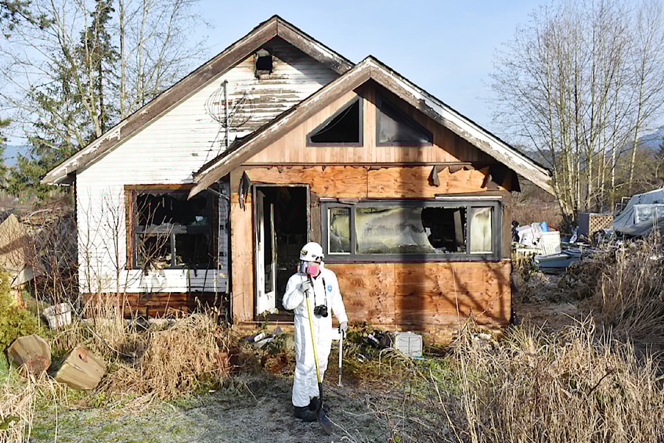Fire prevention inspector Kevin Herd, with Maple Ridge Fire and Rescue, stands outside the scene of a house fire, ahead of an investigation on Wednesday, Jan. 22. 