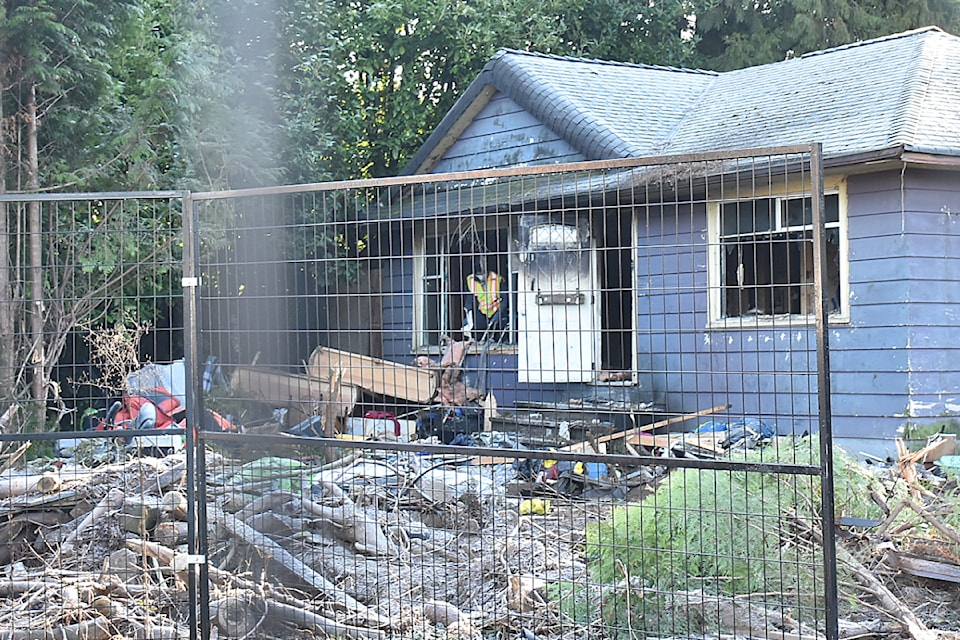 A work crew clears out a house at 22164 Lougheed Highway before it was to be torn down. 