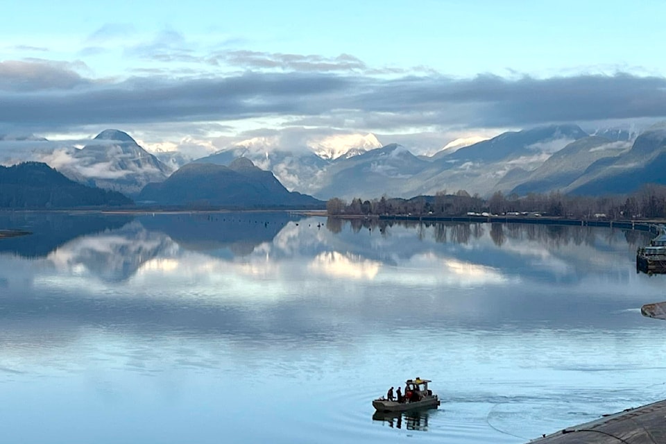 While out for a walk along the dikes earlier this month, Gene Cordoni grabbed this picture of people in a "little boat" that were working on the undercarriage of an overturned barge just north of Pitt River Bridge.