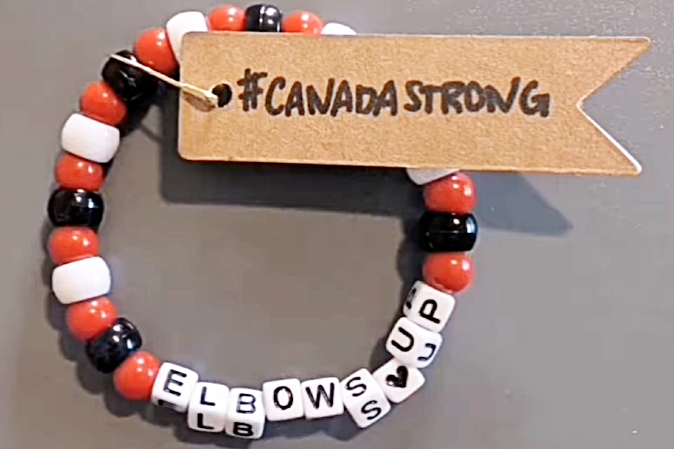 Pitt Meadows-Maple Ridge candidate Angie Rowell presented Liberal Leader Mark Carney with the Elbows Up bracelet made by a Maple Ridge campaign worker. 