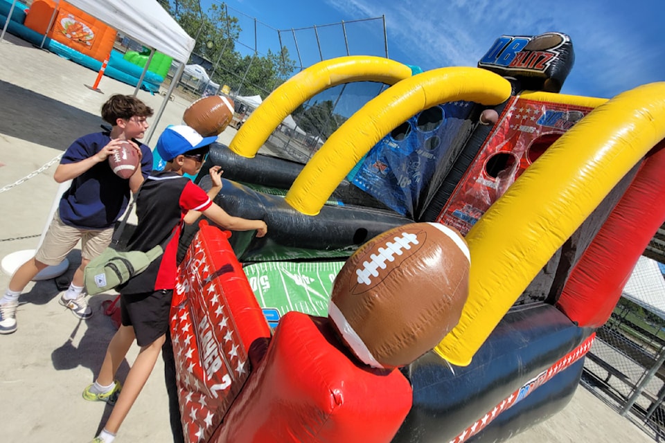 Noah (left) and Cole try a football game.