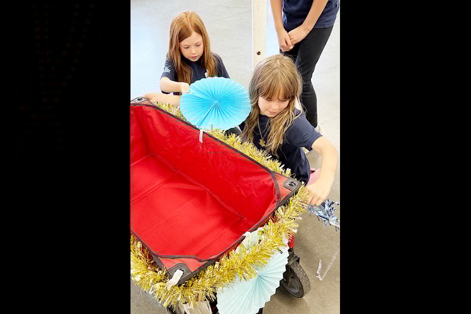 Abigail Erb, left, and Kristin Thurston, both 8, and members of the 3rd Pitt Meadows Sparks and Embers, will be collecting food for the Friends In Need Food Bank at the Pitt Meadows Day Parade on Saturday, June 7. 