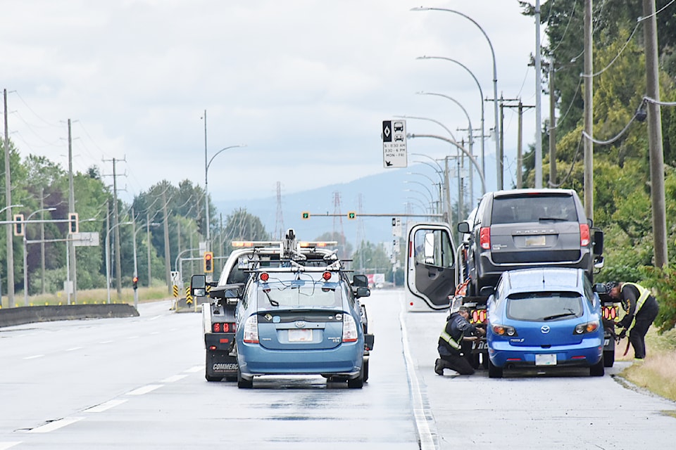 Vehicles are loaded onto tow trucks at the scene of a fatal motor vehicle incident involving a pedestrian in the 18900 block of Lougheed Highway in Pitt Meadows. 