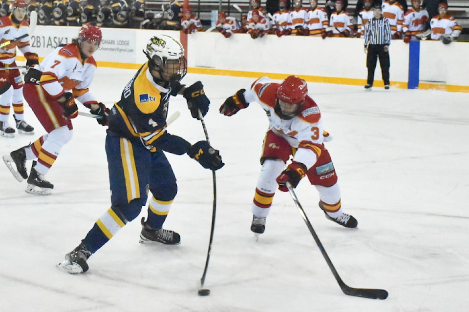 Jakob Loewen tries to get his stick on a Delta shot.