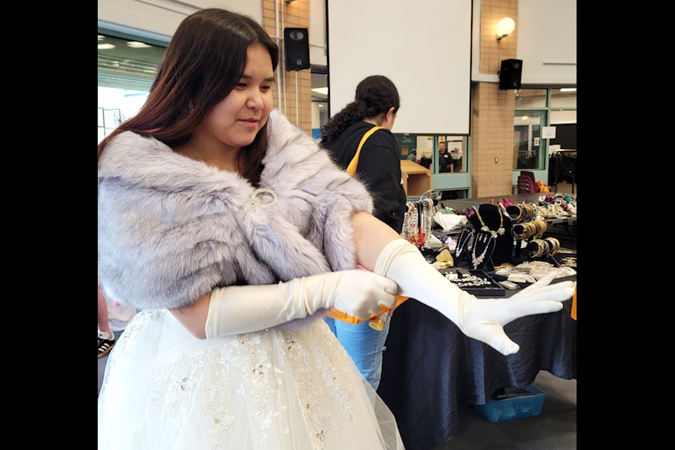 Faith finds a pair of long gloves.