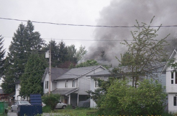 Smoke billows behind homes on the Katzie First Nation in June.