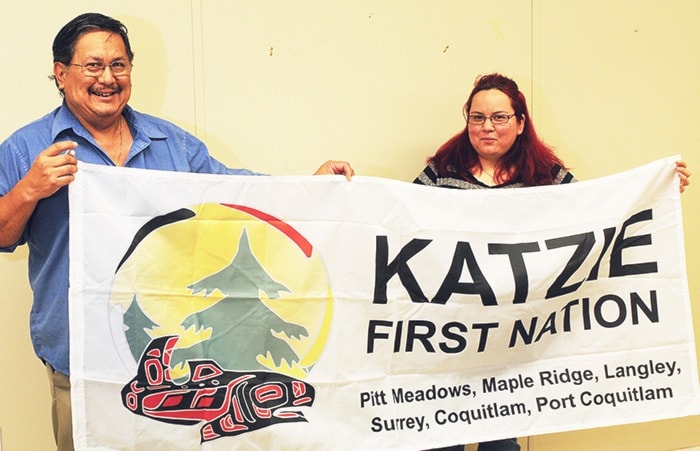 Katzie Coun. Rick Bailey and receptionist Nancy Florence with the band's flag.