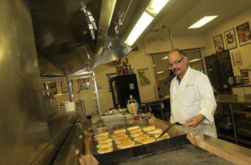 Volunteer Neil Thompson flips pancakes.
12/12/12
COLLEEN FLANAGAN/NEWS