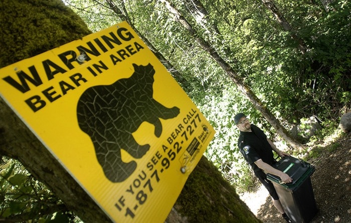 Bylaw enforcement officer Rob Letts with a bear-proof garbage bin.