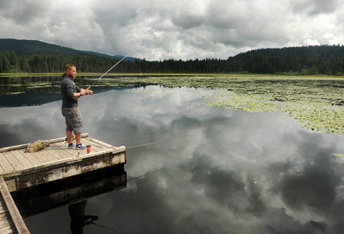 Jamie Leach fishes off the dock at Whonnock Lake on Sunday.