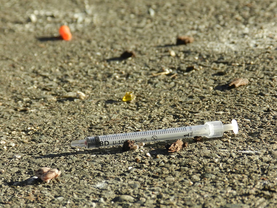 12955058_web1_Drug-needle-discarded-pavement-BP-file