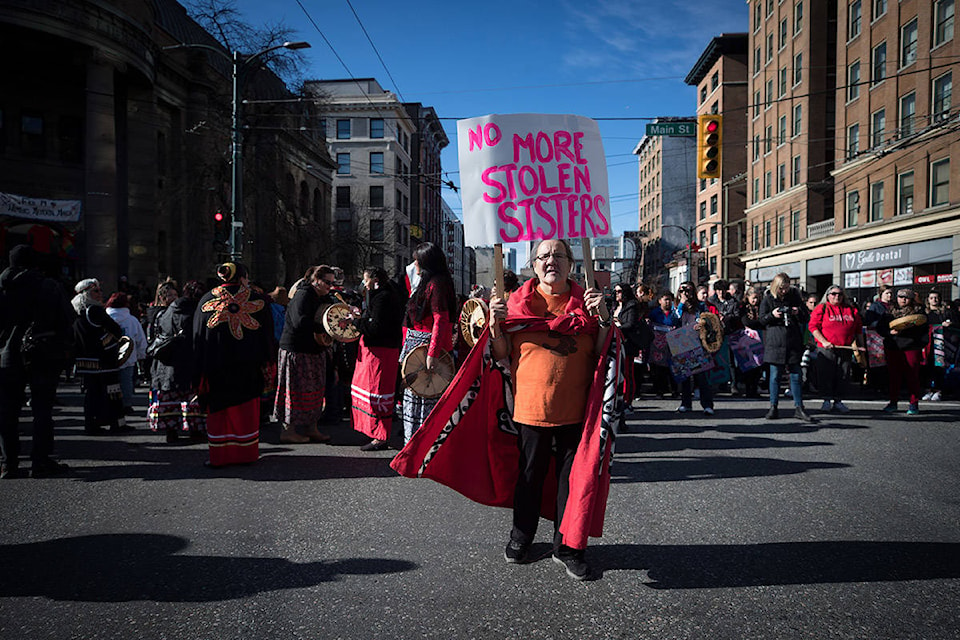 A woman carries a sign during the annual Women’s Memorial March in Vancouver, on Friday February 14, 2020. THE CANADIAN PRESS/Darryl Dyck
