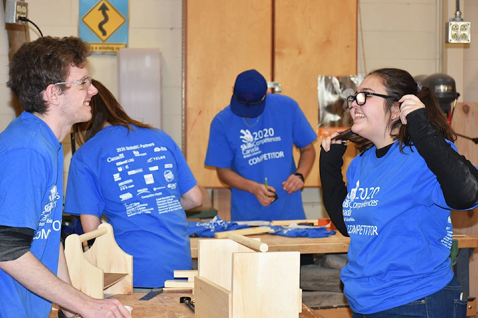 Brayden Hollywood and Emily Hamilton from Samuel Robertson Technical share a mid-competition laugh in the Skills Canada cabinet making contest at Westview Secondary. (Ronan O’Doherty-THE NEWS)