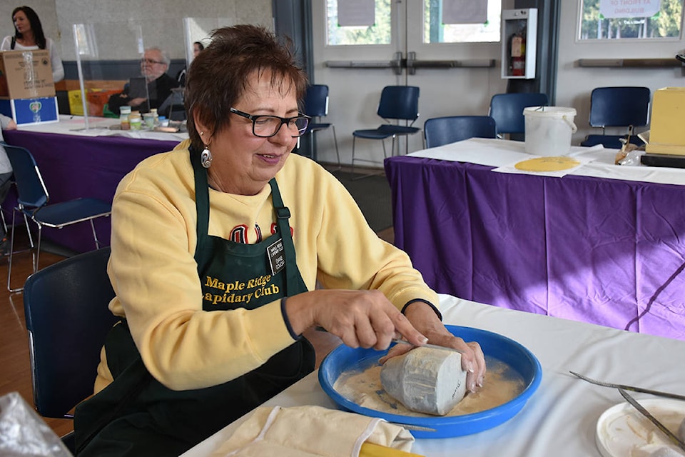 Diane Cougar carves a seal head rising out of the water at Maple Ridge Lapidary Club’s 62nd annual Rock and Gem show Saturday. (Ronan O’Doherty - THE NEWS)