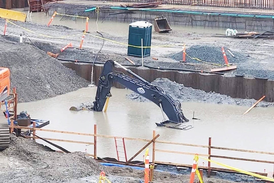 An excavator is underwater at the new pump station being built at Golden Ears Way and 113B Avenue. (Special to The News)
