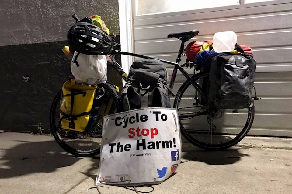 Iliajah Pidskalny’s bike is adorned with a sign advertising his cause. He has raised $21,000 for Canadian Drug Policy Coalition and Moms Stop the Harm. (Photo/Iliajah Pidskalny)