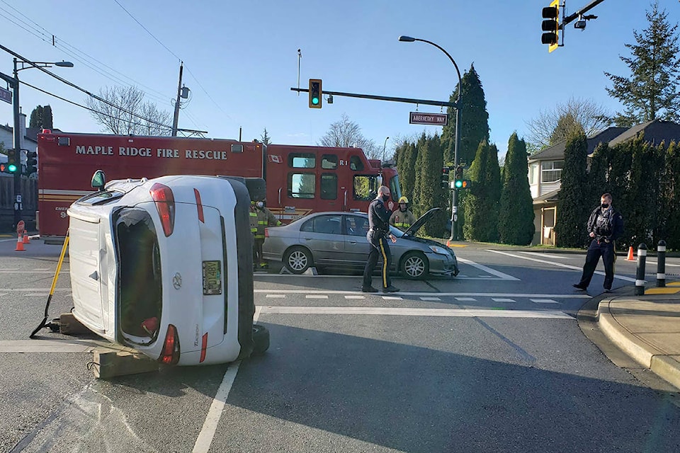 A white Hyundai Tuscon rolled over onto its side after a collision at 228th Street and Abernethy Way. (Neil Corbett/ The News)