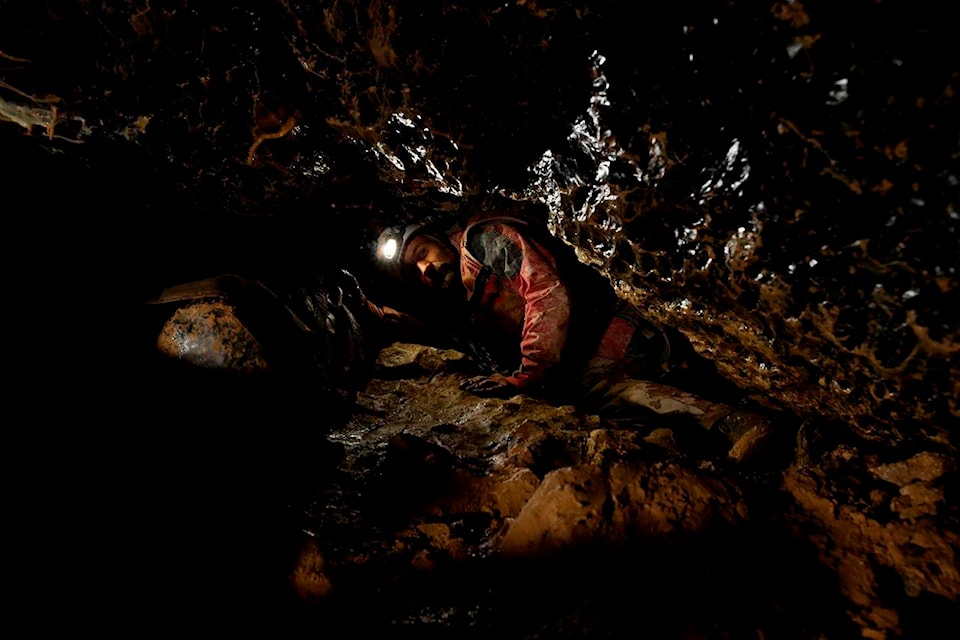In this photo provided by the Human Adaptation Institute on Saturday, April 24, 2021, a member of the team taking part in the “Deep Time” study explores the Lombrives Cave in Ussat les Bains, France. After 40 days in voluntary isolation, 15 people participating in a scientific experiment have emerged from a vast cave in southwestern France. Eight men and seven women lived in the dark, damp depths of the Lombrives cave in the Pyrenees to help researchers understand how people adapt to drastic changes in living conditions and environments. They had no clocks, no sunlight and no contact with the world above. (Human Adaptation Institute via AP)