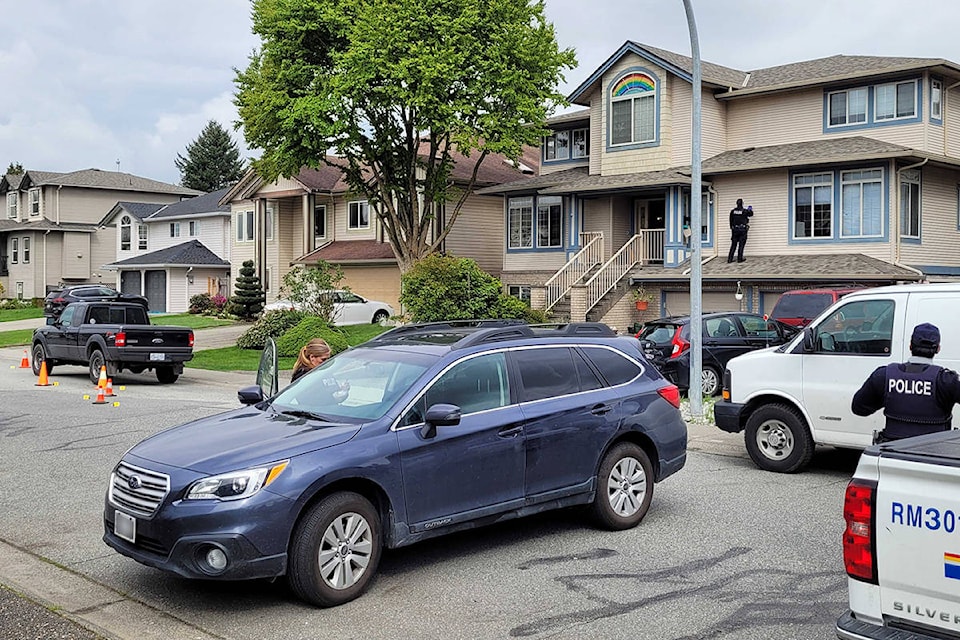 RCMP are in the 18800-block of 122nd Avenue in Pitt Meadows Monday morning (April 26, 2021) as they investigate an overnight shooting that targeted the wrong home. (Neil Corbett/The News)