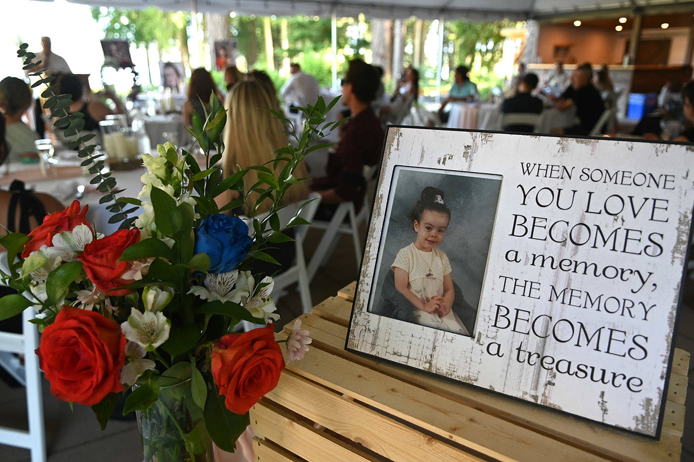 A photo of Shaelene Bell when she was a child sits on a table during her celebration of life at Sandpiper Resort on Saturday, June 26, 2021. (Jenna Hauck/ Chilliwack Progress)