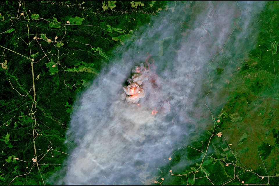 This satellite image provided by European Union, Copernicus Sentinel-2 data (processed by Spacetec) shows a wildfire burning 40 km (about 25 miles) northeast of Pink Mountain in British Columbia. (European Union, Copernicus Sentinel-2 data via AP)