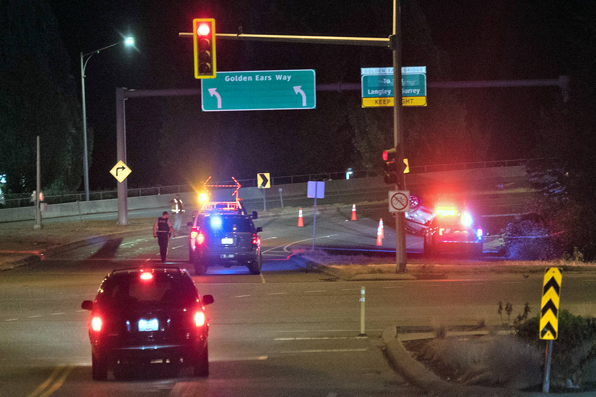 Multiple police vehicles were called to the scene of a rollover on the Golden Ears Bridge on-ramp Saturday night, Aug. 7. (Barry Brinkman/Special to Maple Ridge - Pitt Meadows News)