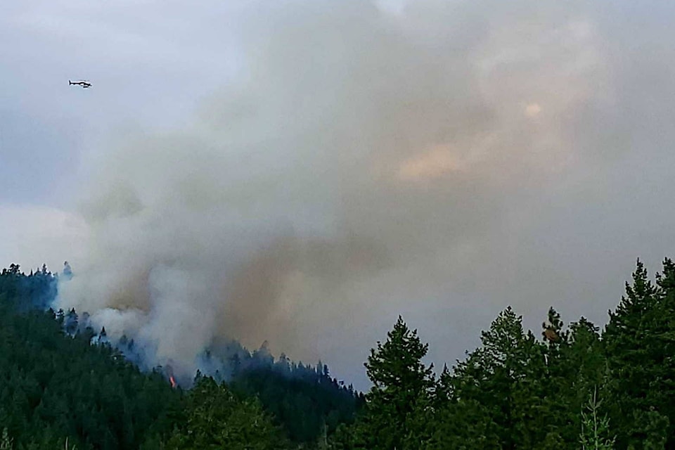 Smoke and a helicopter visible near Peachland on Sunday, Aug. 15. (Kerry Hutter photo)