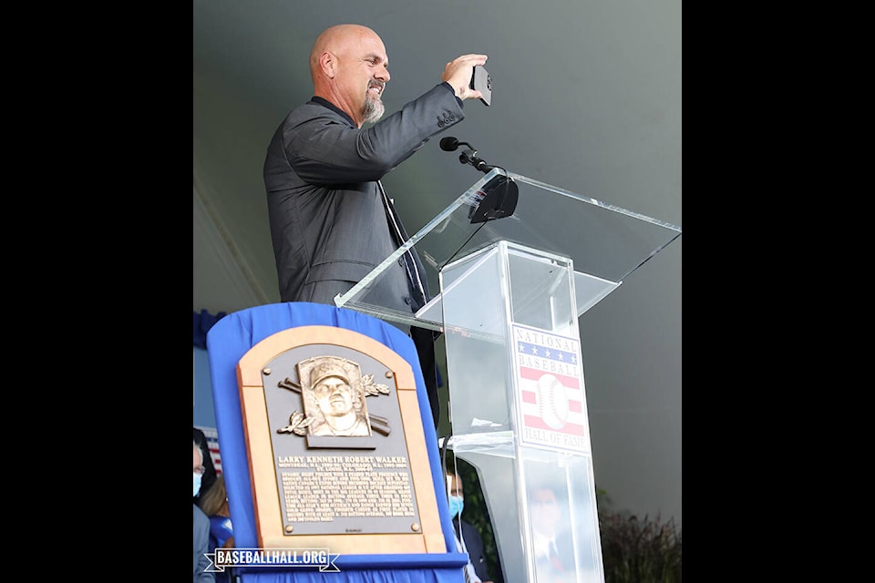 Larry Walker takes a photo at the podium during the Hall of Fame induction ceremony on Wednesday. (National Baseball Hall of Fame and Museum Facebook)