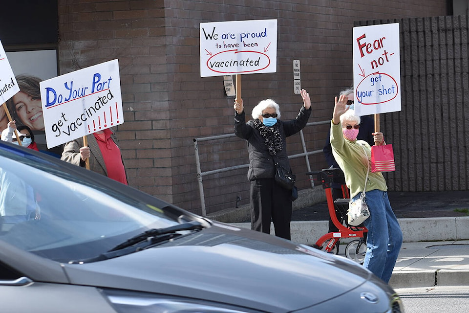 A group of about a dozen Semiahmoo Peninsula seniors rallied in support of COVID-19 vaccinations Friday afternoon in White Rock. (Nick Greenizan photo)