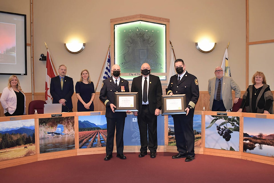 Fire chief Mike Larsson and paid-on-call assistant chief Dave Saddler being presented with Outstanding Service Awards by Mayor Bill Dingwall. (City of Pitt Meadows/Special to The News)